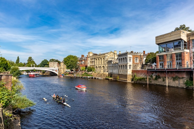view of boats on the river Ouse in York with The Guildhall in the background