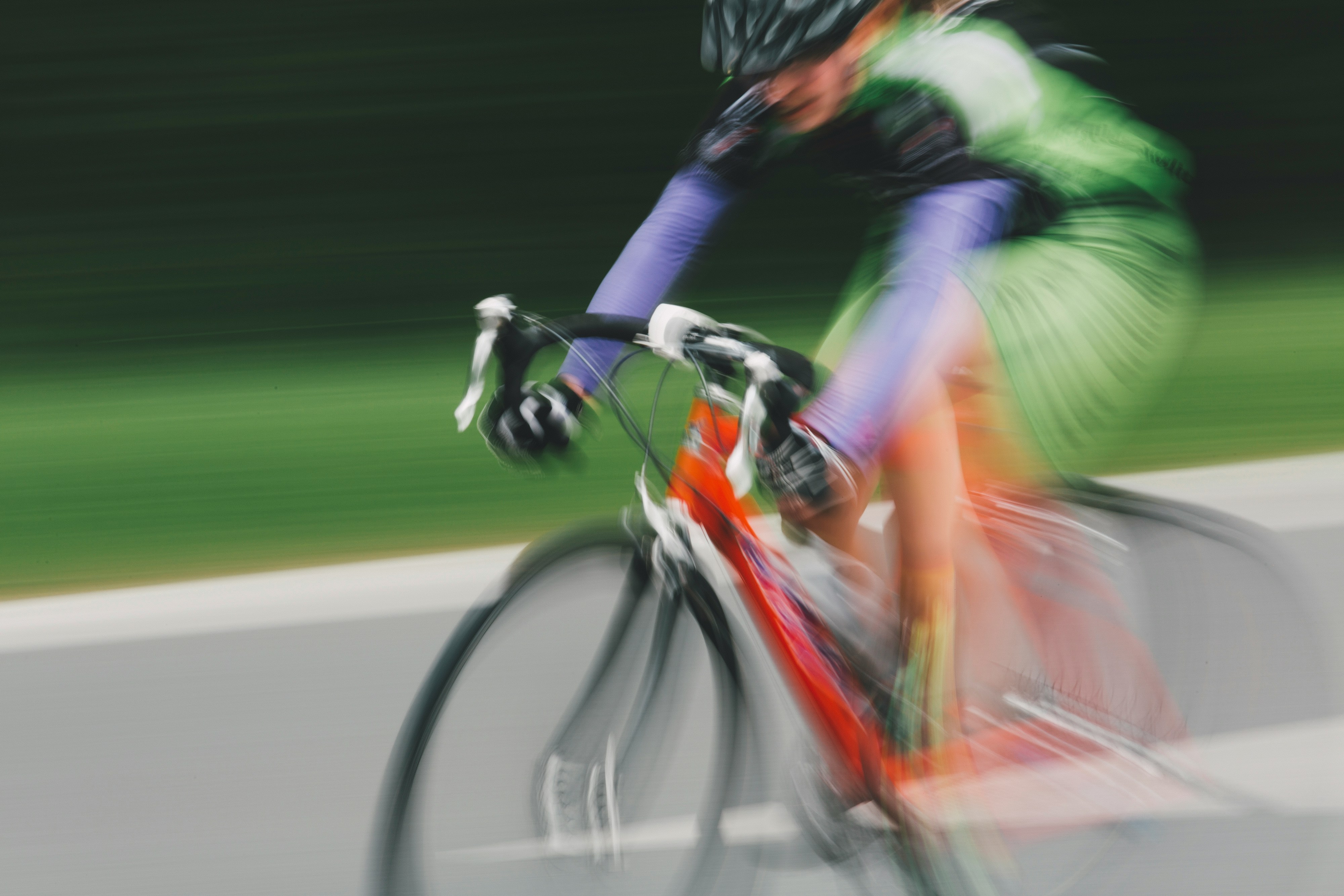 blurred man racing on a red cycle