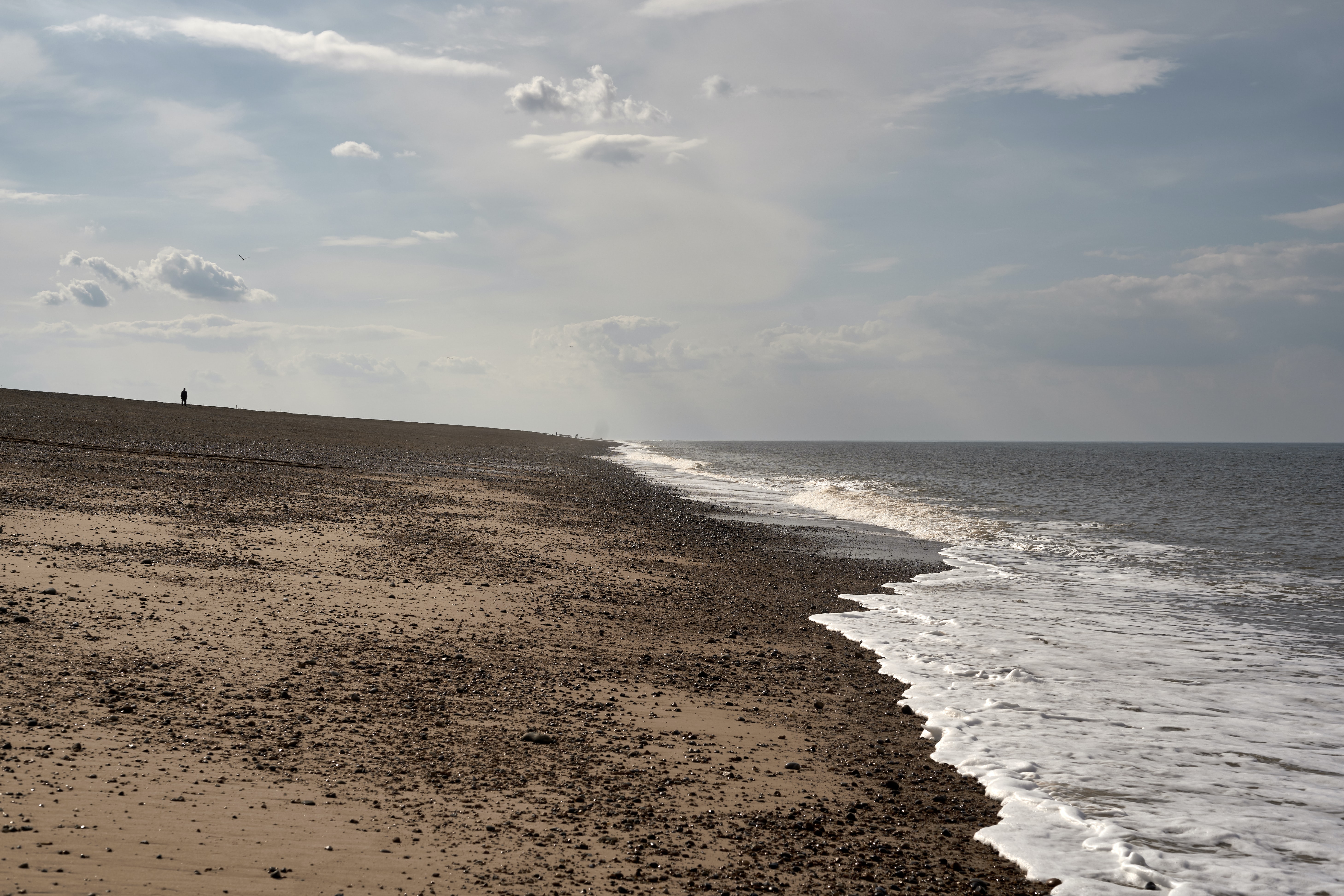 view of a sandy beach and the foaming sea